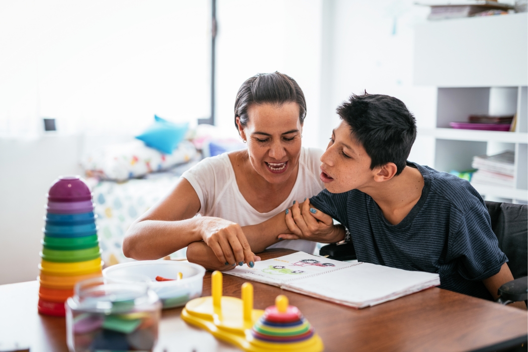 NDIS support coordinator assisting a young person with disability in a learning activity